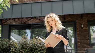 A business professional reading a book outdoors, symbolizing top sales books for agents to grow their expertise. A business professional reading a book outdoors, symbolizing top sales books for agents to grow their expertise.