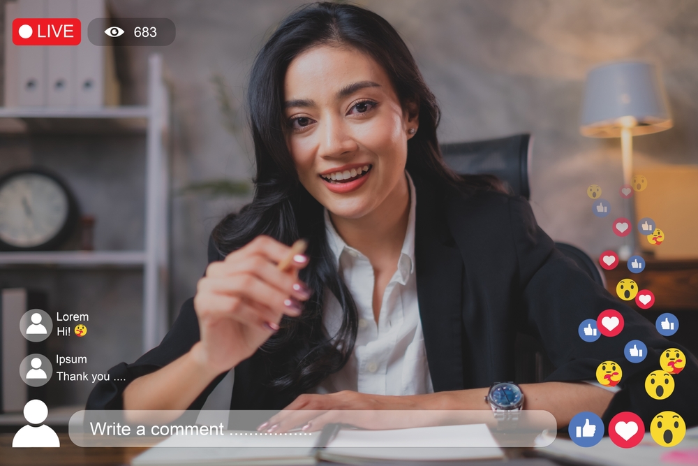 A female independent insurance agent is teaching online class while live streaming, using social media to encourage business, Concept investing, business, life coaching or insurance class. 