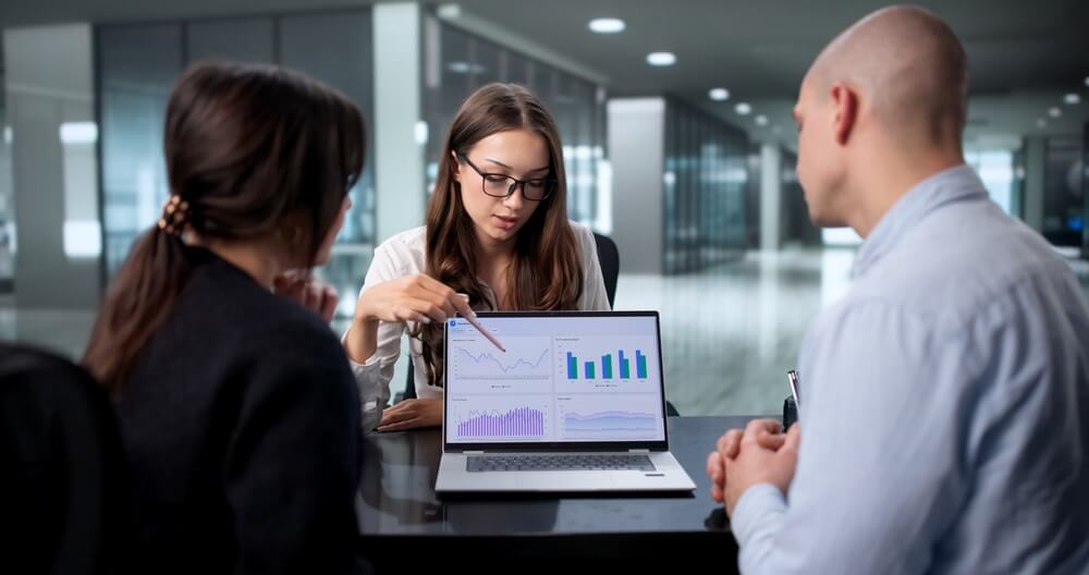Independent insurance agent reviews charts with clients during a planning meeting, showing how independent insurance agents can become the first choice for clients.
