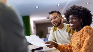 Independent Insurance Agent in the Southwest discussing coverage options with clients at an office Independent Insurance Agent in the Southwest discussing coverage options with clients at an office