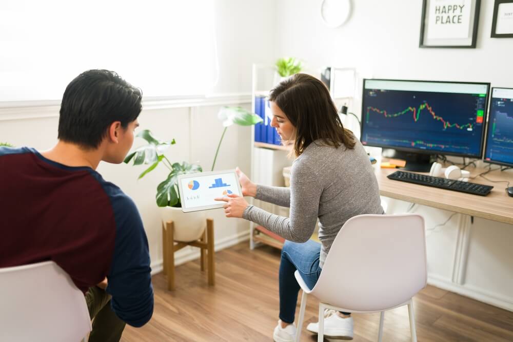 A male and female form Gen Z compare information and technology.