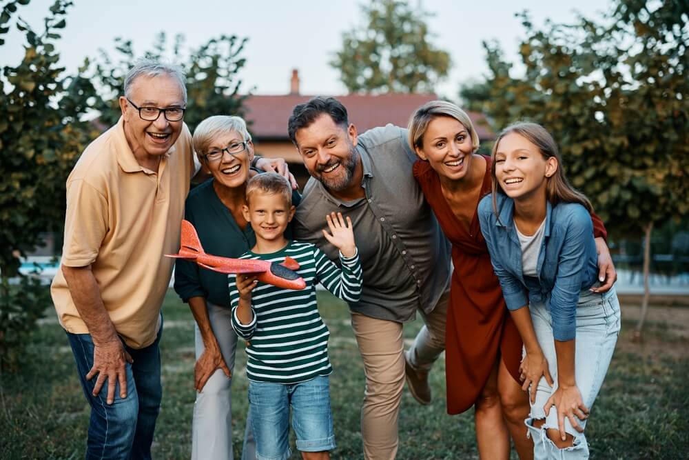 Multigenerational family smiling at the camera.