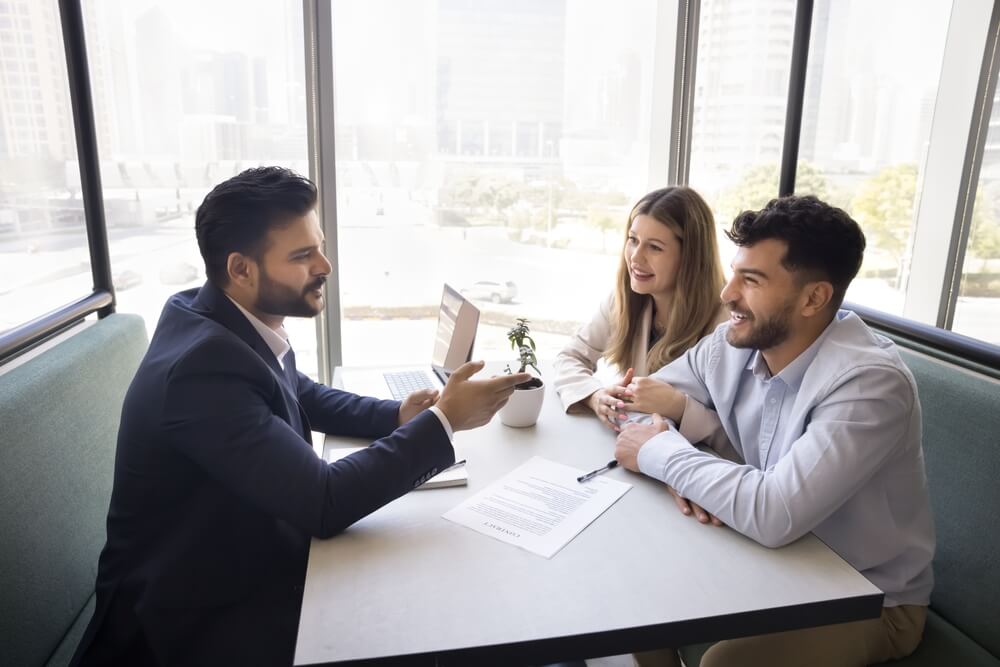 Independent agent meeting with clients and using data insights to sell smarter and personalize recommendations.