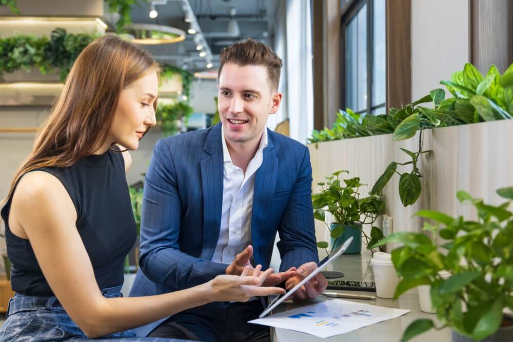 Two insurance agents work together to learn from each other and support each other - independent agent support. 