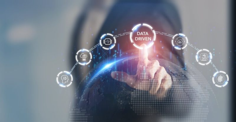 A finger hovers over a button that says data driven, concept of modern insurance agency business.