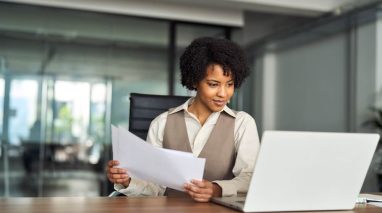 Professional busy young independent insurance agent business woman working with important continuous learning sitting at office desk.