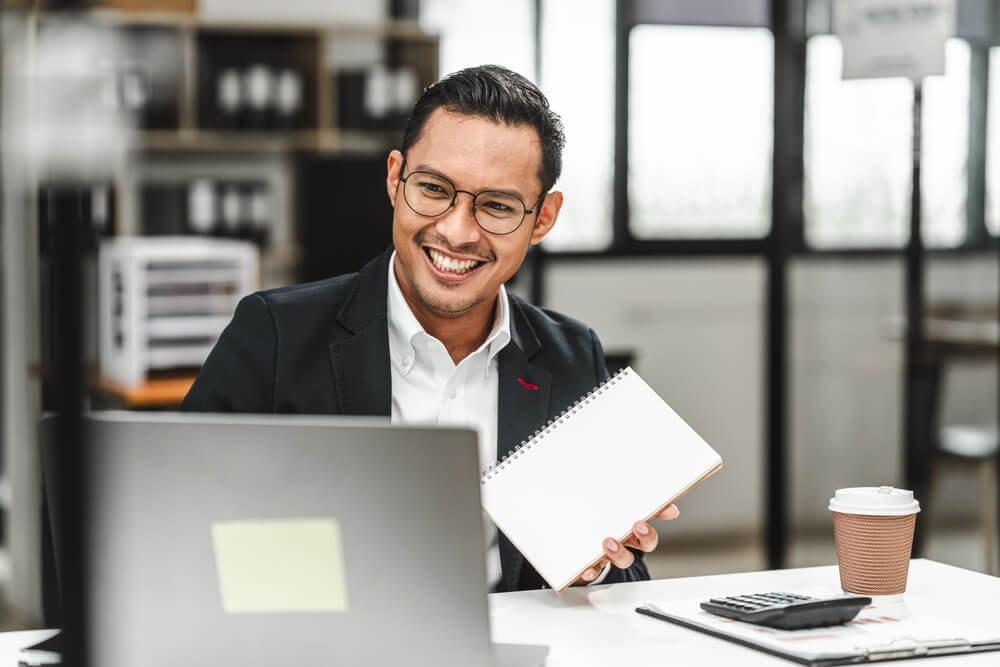 Independent insurance agent businessman working at desk, taking CEs and doing continuous learning.