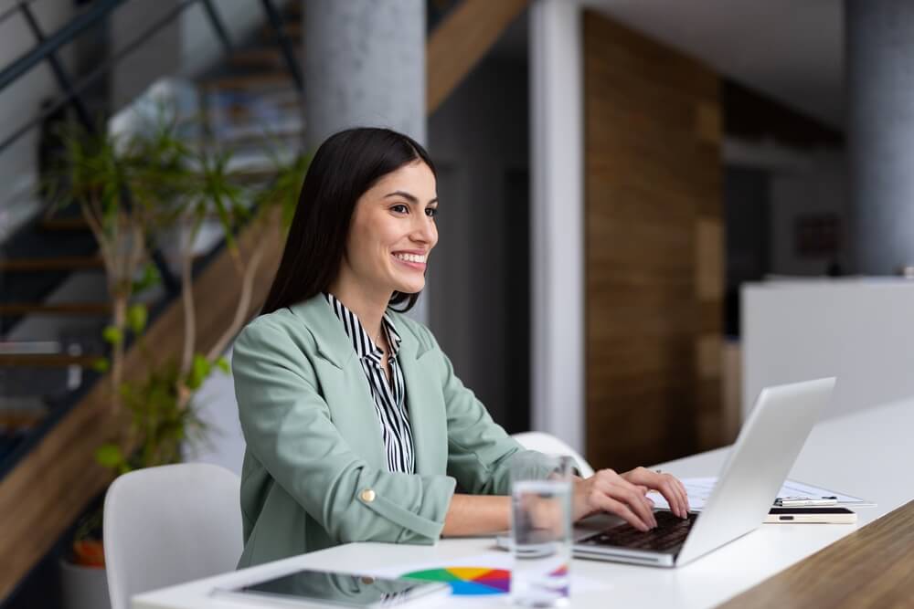 Insurance agent smiling because she's giving her Insurance customers a great experience