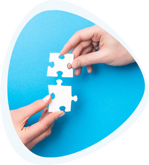 Two hands with matching puzzle pieces.