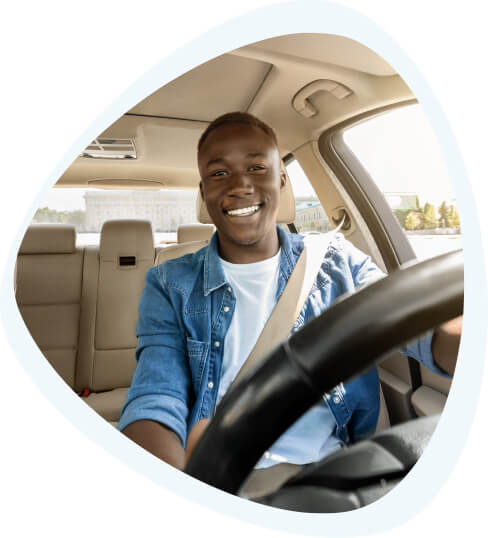 Young African-American behind the wheel of a car.
