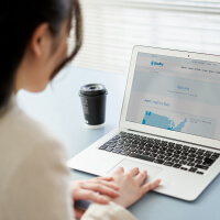 Side view of woman with laptop open.