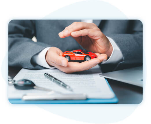 img-intern-1-our-products Businessperson hand holding red car with other hand providing a shelter.