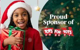 A smiling child wearing a Santa hat and red sweater holds a wrapped gift next to text that reads “Proud Sponsor of Toys for Tots” with a decorated Christmas tree in the background.
